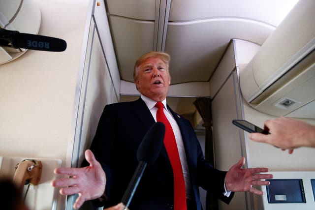 US President Donald Trump speaks to the press aboard Air Force One en route to Bedminster, New Jersey, from Joint Base Andrews, Maryland, US on 29 June 2018