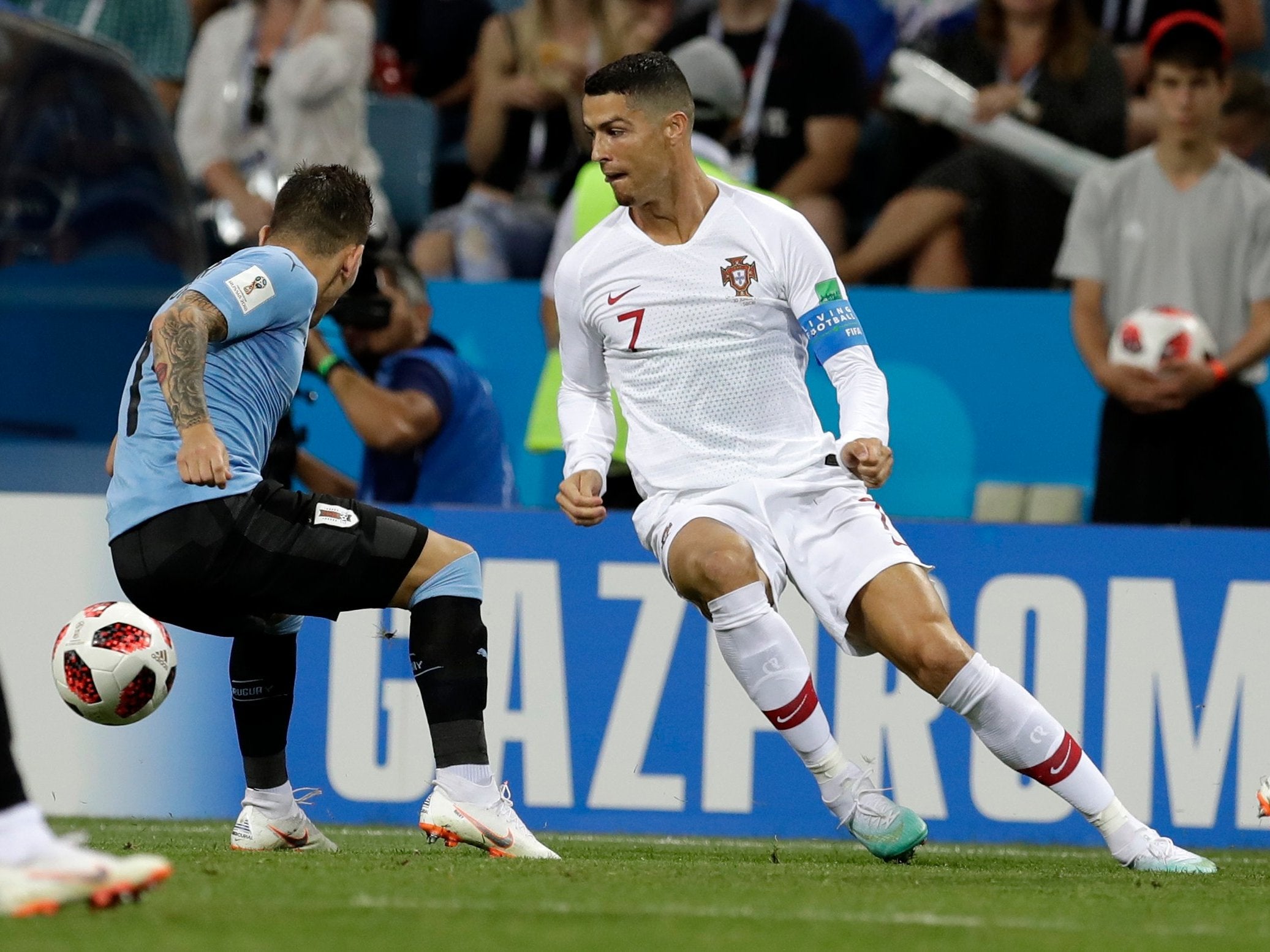 Uruguay's Torreira, left, challenges Ronaldo