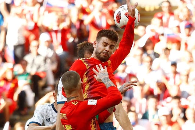 Gerard Pique handballs to allow Artem Dzyuba to score a penalty to equalise for Russia