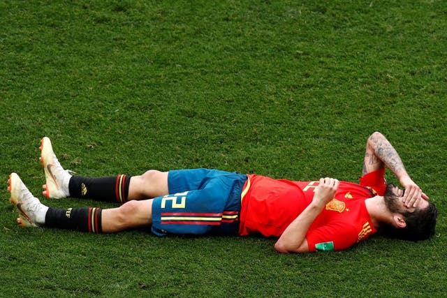 Down and out: Isco reacts to Spain's World Cup defeat by Russia