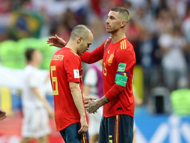 Andres Iniesta is consoled by Sergio Ramos