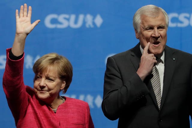 Horst Seehofer (right) has offered to resign as interior minister