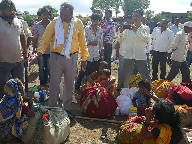 Village leaders speak to relatives of men killed in Dhule district, some 330km (205 miles) outside Mumbai