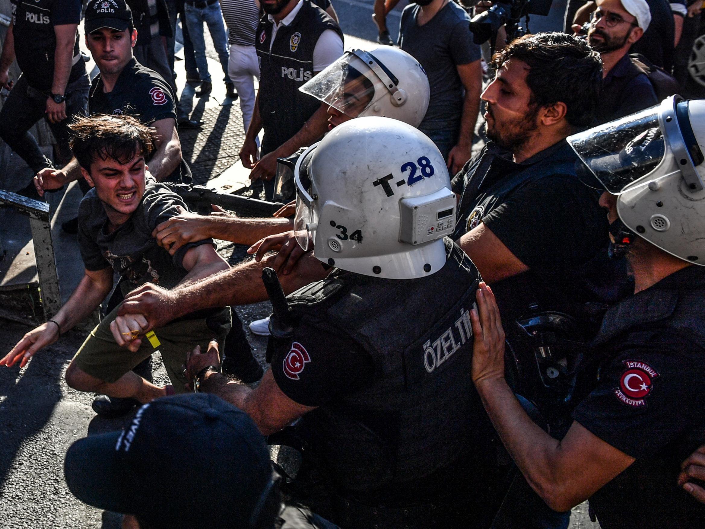 Riot policemen beat a LGBT rights activist after Turkish authorities banned the event for a fourth year in a row
