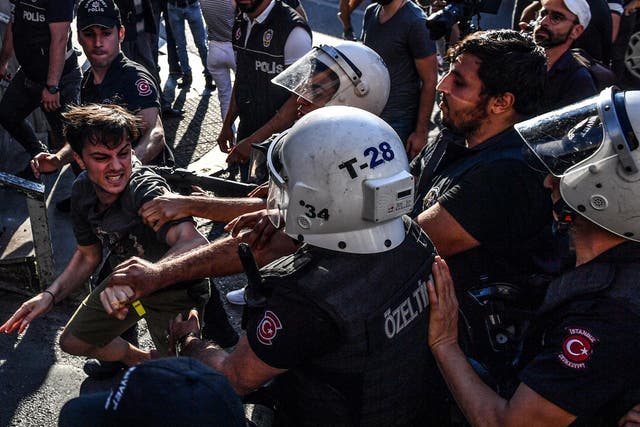 Riot policemen beat a LGBT rights activist after Turkish authorities banned the event for a fourth year in a row