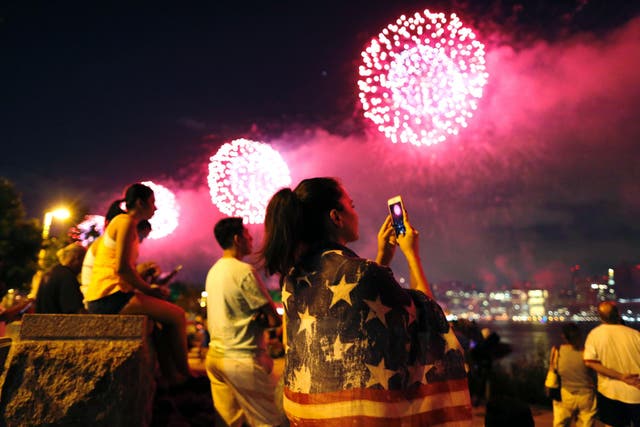 <p>People watch a fireworks show in Queens, New York</p>