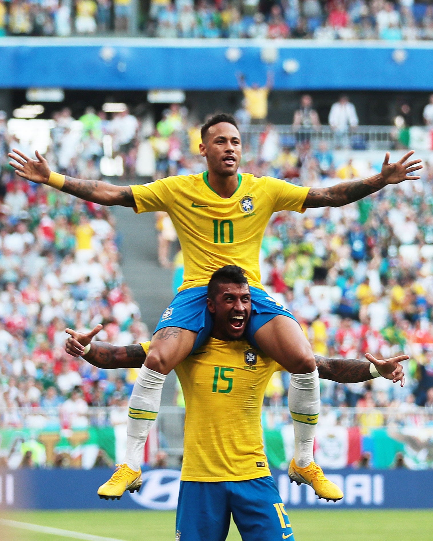 Neymar and Paulinho of Brazil celebrate