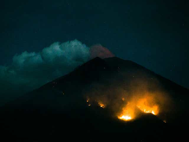 Forest fires seen on the slopes of Mount Agung following an eruption late on Monday