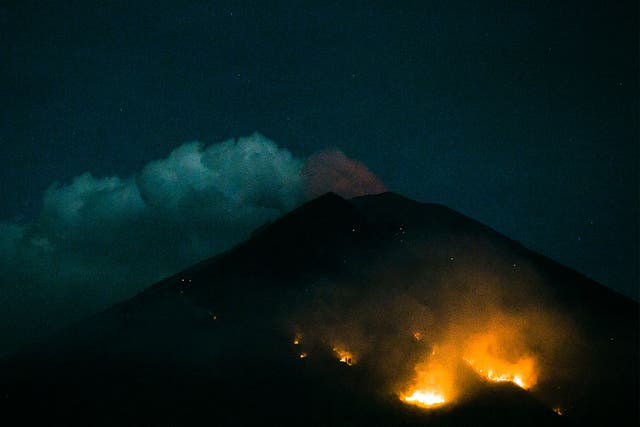 Forest fires seen on the slopes of Mount Agung following an eruption late on Monday
