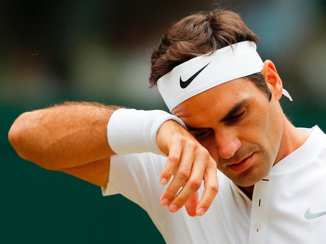 Roger Federer wipes sweat away from his brow at Wimbledon