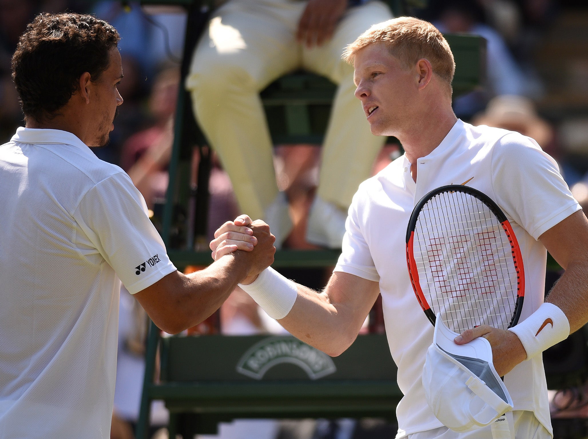 The pair shake hands after their first round match