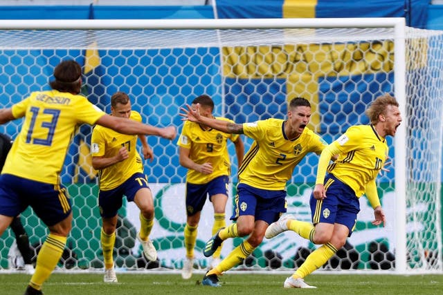 Sweden's Emil Forsberg celebrates scoring their first goal with teammates