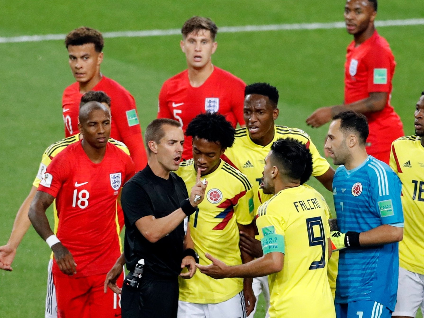 Radamel Falcao confronts Mark Geiger during Colombia's game against England