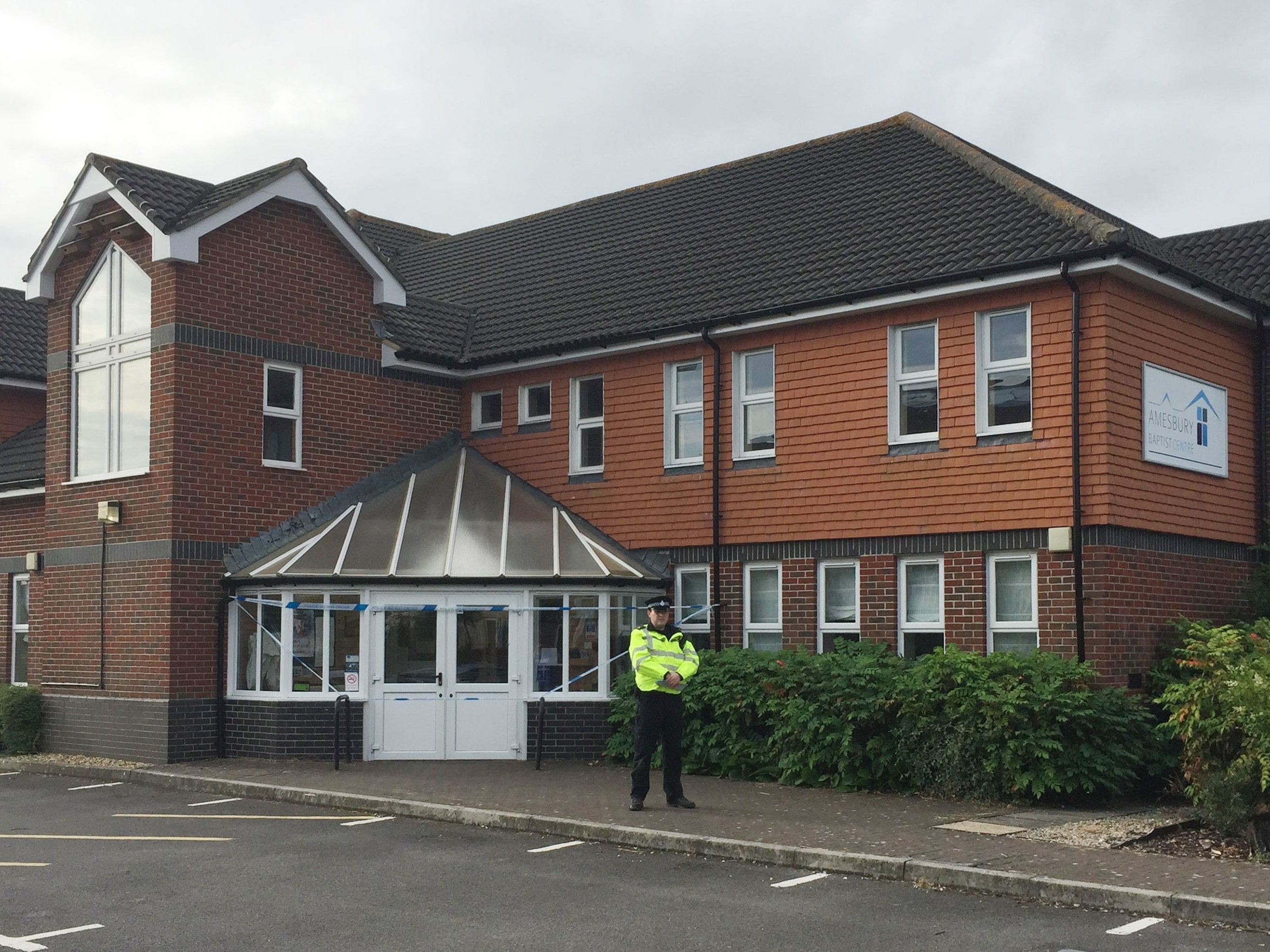 A police officer stands outside Amesbury Baptist Church in Wiltshire