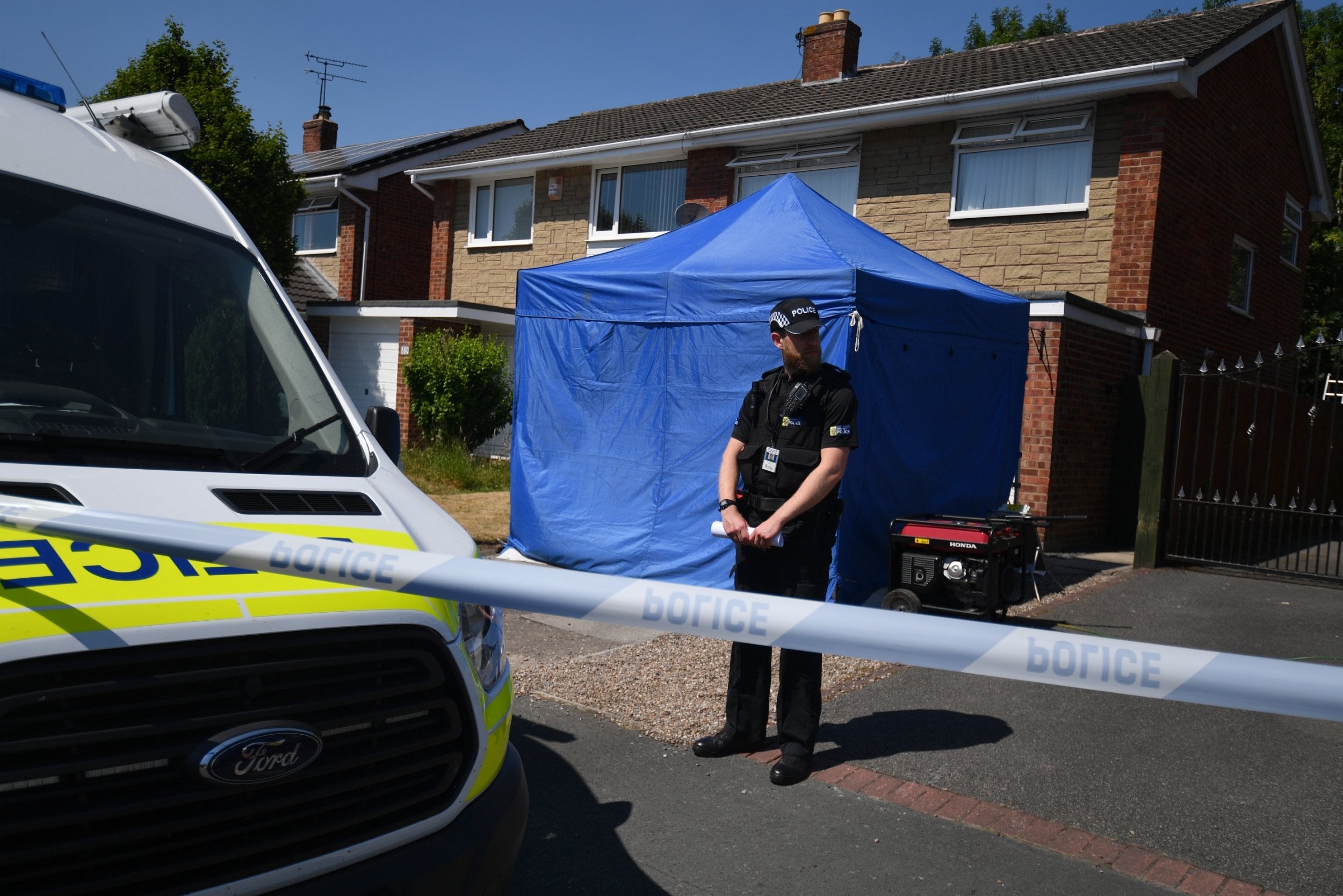 A police officer stands outside a home Chester after a healthcare professional working at the Countess of Chester Hospital was arrested on suspicion of murdering eight babies