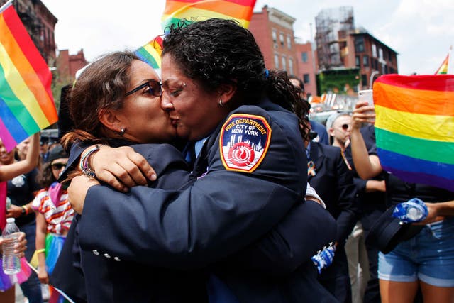 EMT Trudy Bermudez and paramedic Tayreen Bonilla of New York City Fire Department get engaged at the annual Pride Parade on June 24, 2018 in New York City