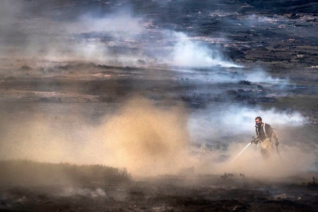 Firefighters tackle the wildfire on Saddleworth Moor