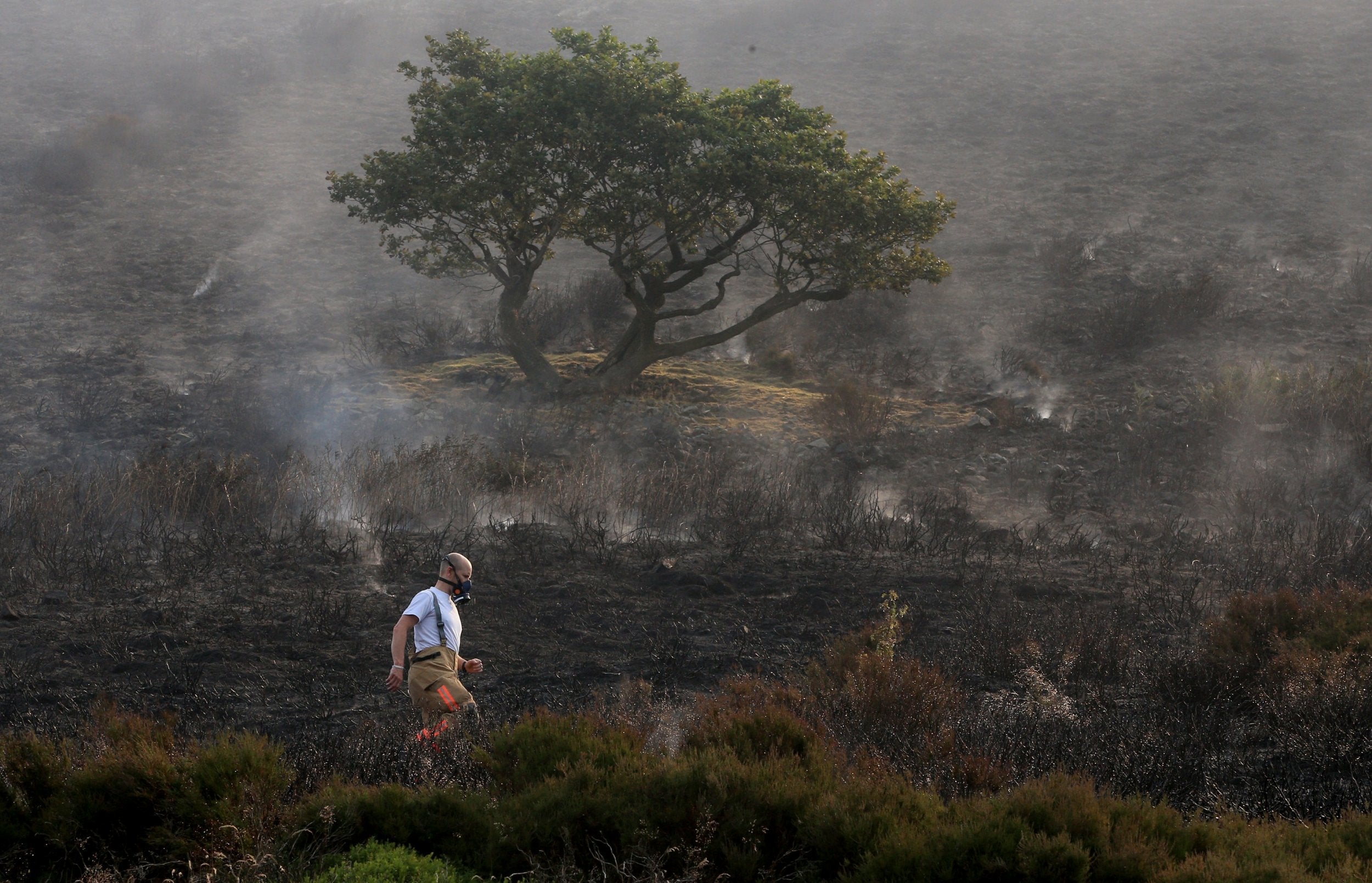 Firefighters tackle the wildfire on Saddleworth Moor, which continues to spread after the blaze was declared a major incident by Greater Manchester Police