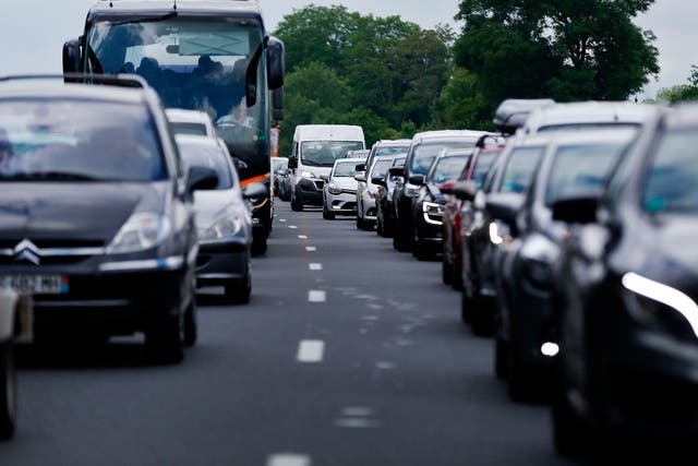 Motorists wait on the A13 highway during a traffic jam near the French town of Annebault