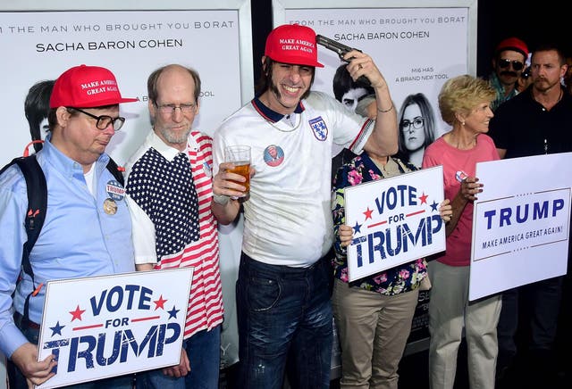 Actor Sacha Baron Cohen poses with Donald Trump supporters