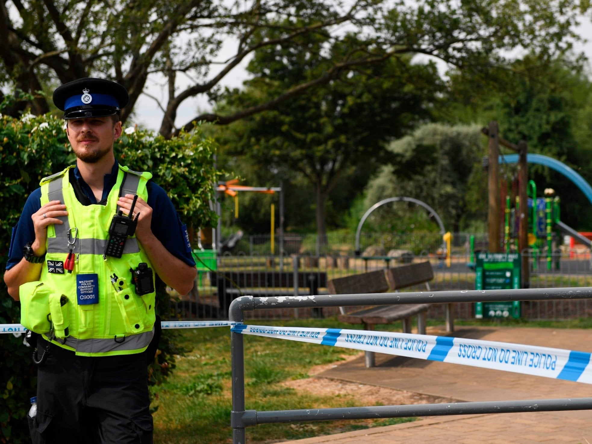 A police officer stands at a cordon by a play park at Queen Elizabeth Gardens in Salisbury