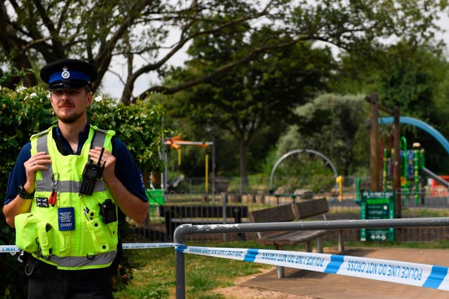 A police officer stands at a cordon by a play park at Queen Elizabeth Gardens in Salisbury
