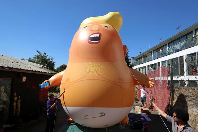 People inflated a helium-filled Donald Trump blimp during The President of the United States' visit to London