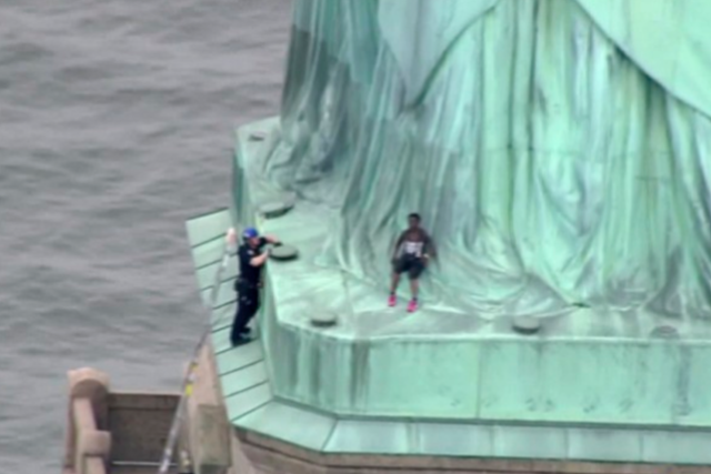 Credit: AP

Protester identified as Therese Patricia Okoumou seen protesting at the base of the Statue of Liberty on Independence Day.