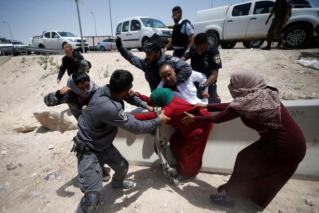 Israeli police try to detain Palestinians in the Bedouin village of Khan al-Ahmar in the occupied West Bank on 4 July, 2018