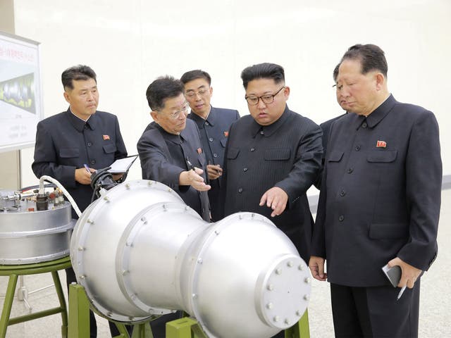 North Korean leader Kim Jong-un inspects a device constructed as part of the country's nuclear weapons programme