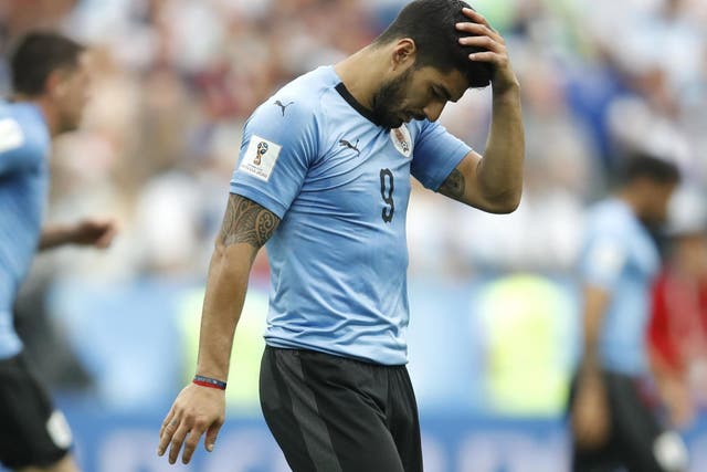 Luis Suarez reacts after France scored their second goal