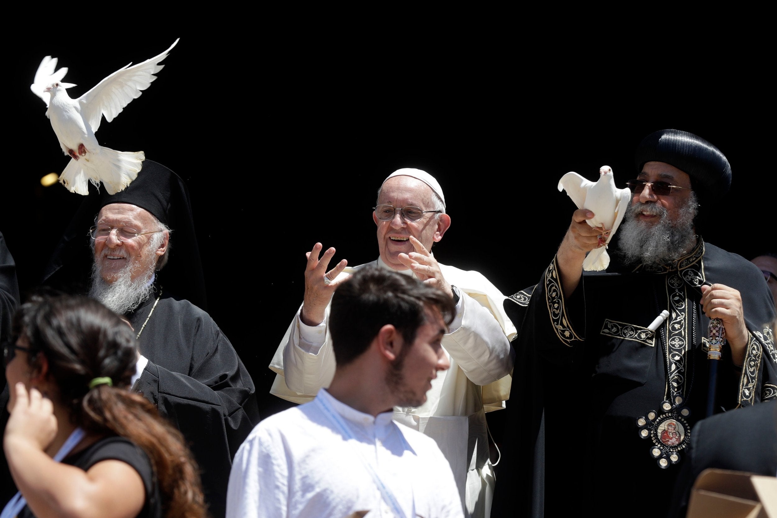 Pope Francis, center, flanked by Ecumenical Patriarch Bartholomew I, left, and Tawadros II, Pope of Alexandria and Patriarch of the See of St. Mark, free doves in Bari