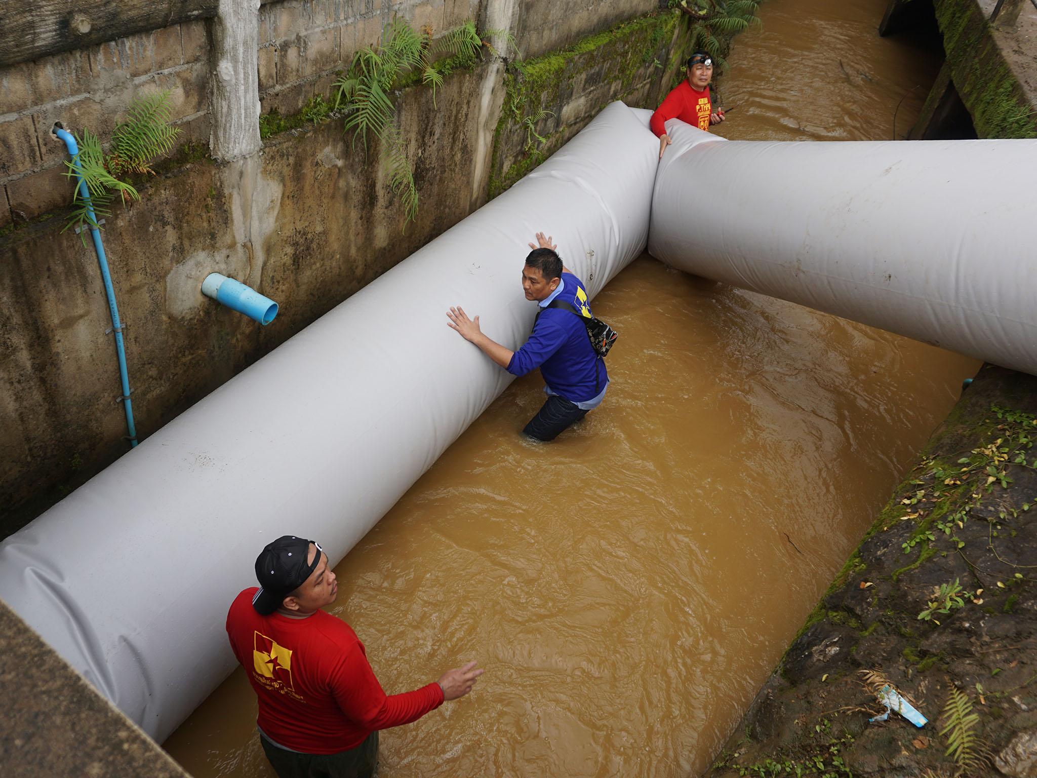 Volunteers guide Ms Sthpanik on a test-crawl through the inflated tunnel (Matt Blomberg)