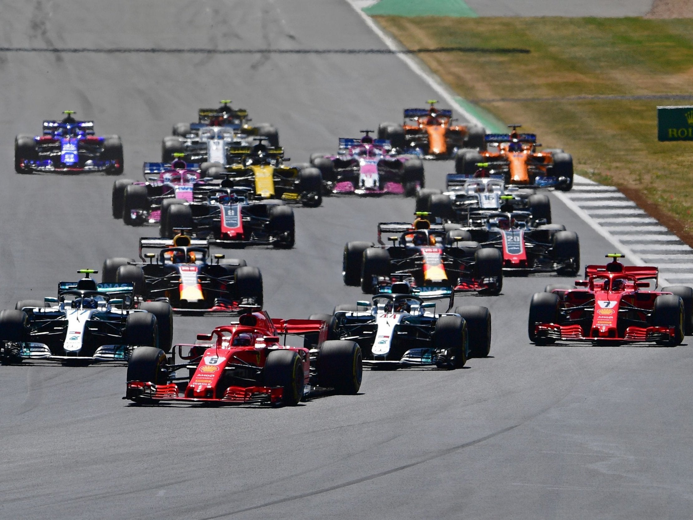 Sebastian Vettel overtakes Lewis Hamilton at the start of the British Grand Prix