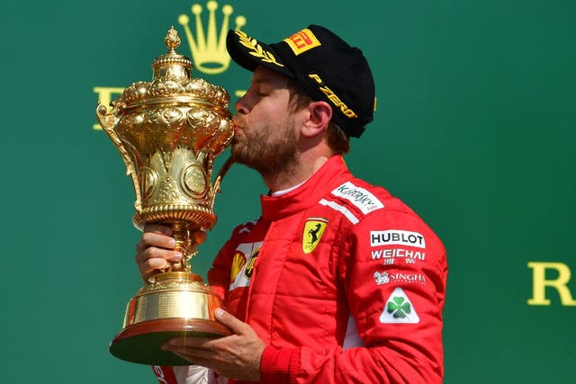 Sebastian Vettel celebrates his British Grand Prix victory on the Silverstone podium