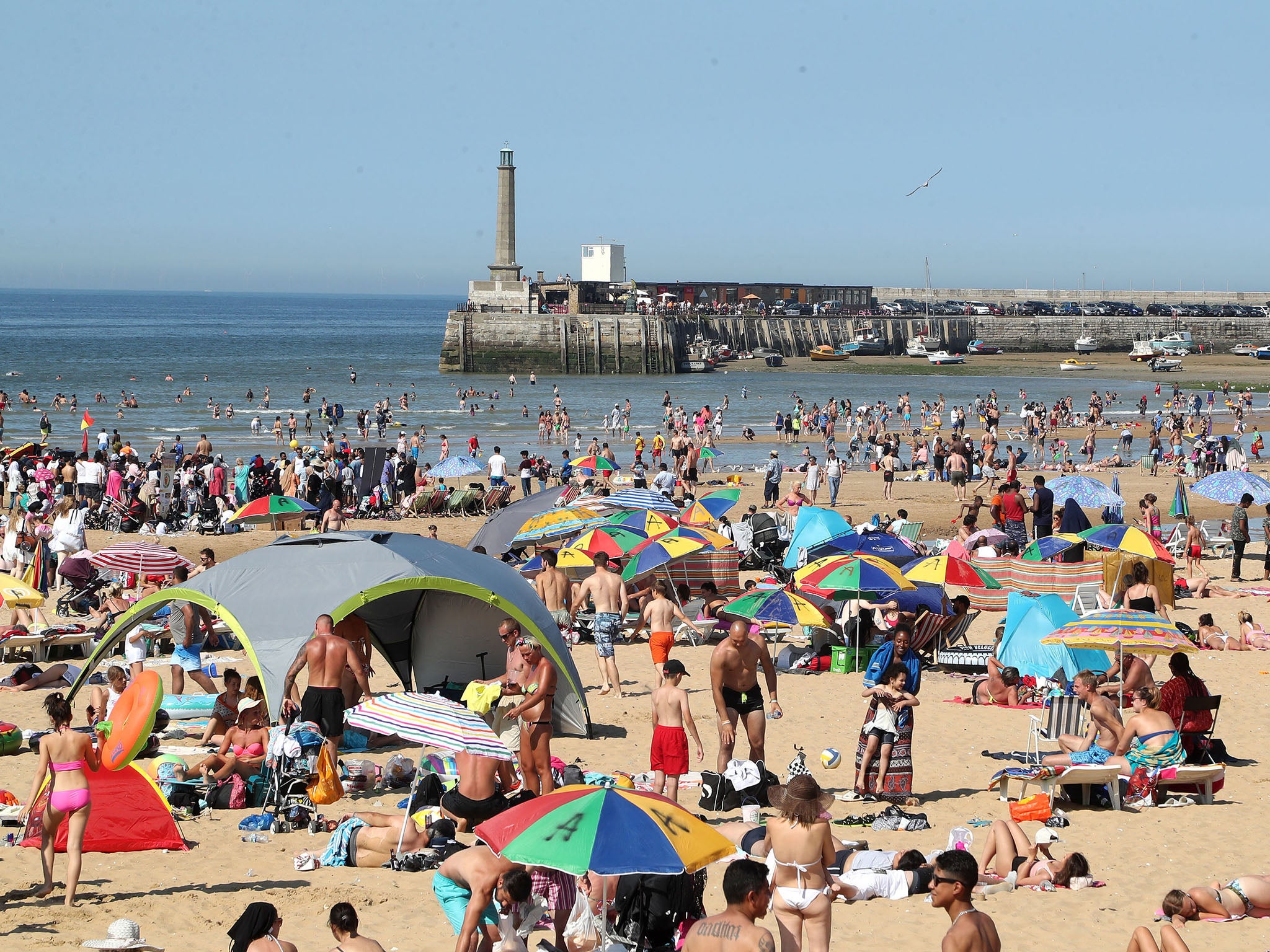 People enjoy the hot weather on the beach in Margate, Kent.