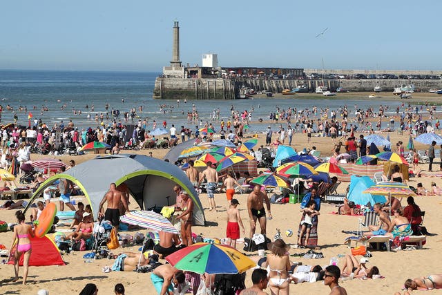 People enjoy the hot weather on the beach in Margate, Kent.