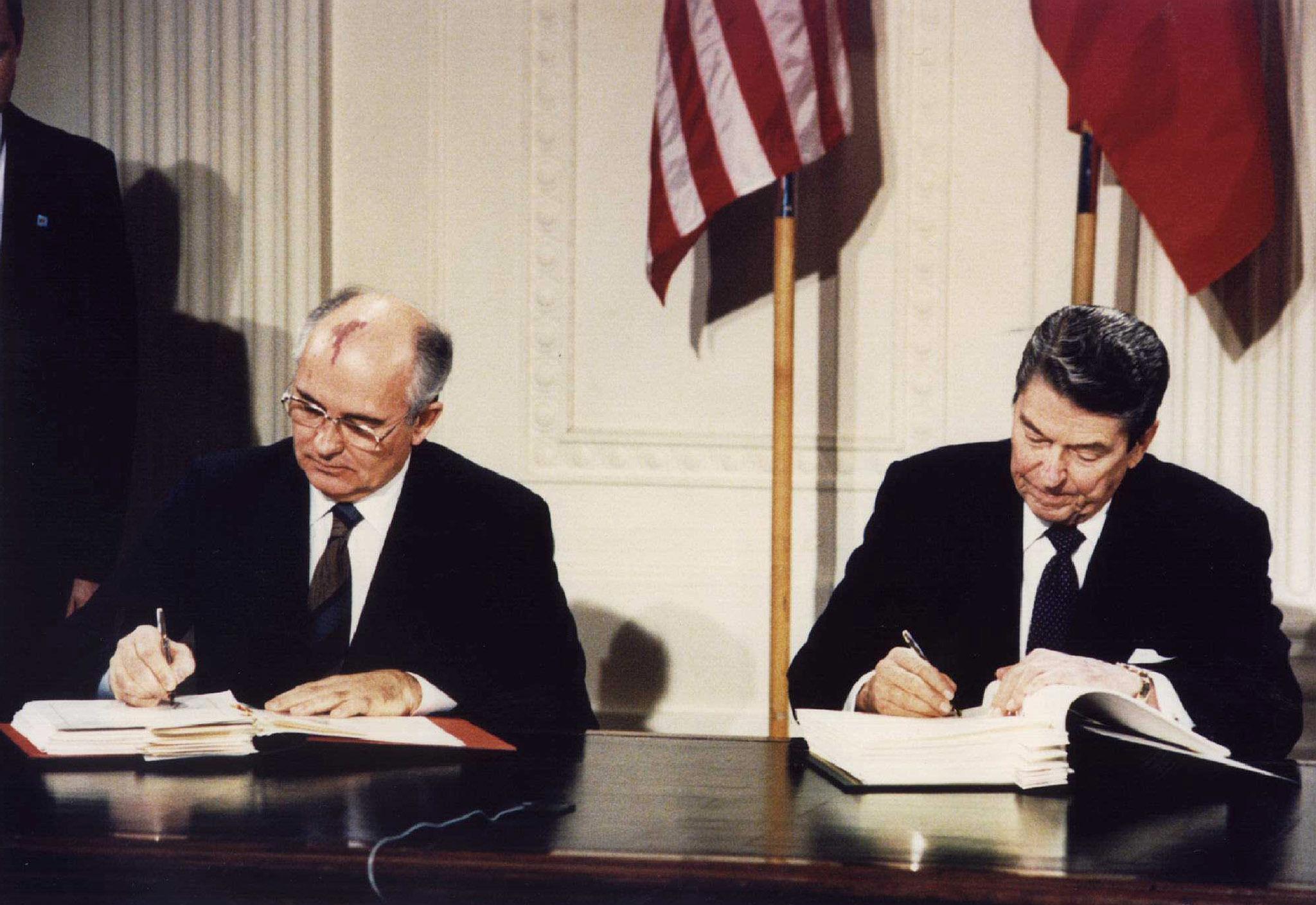Soviet president Mikhail Gorbachev and US president Ronald Reagan signing the Intermediate-Range Nuclear Forces Treaty at the White House on 8 December 1987
