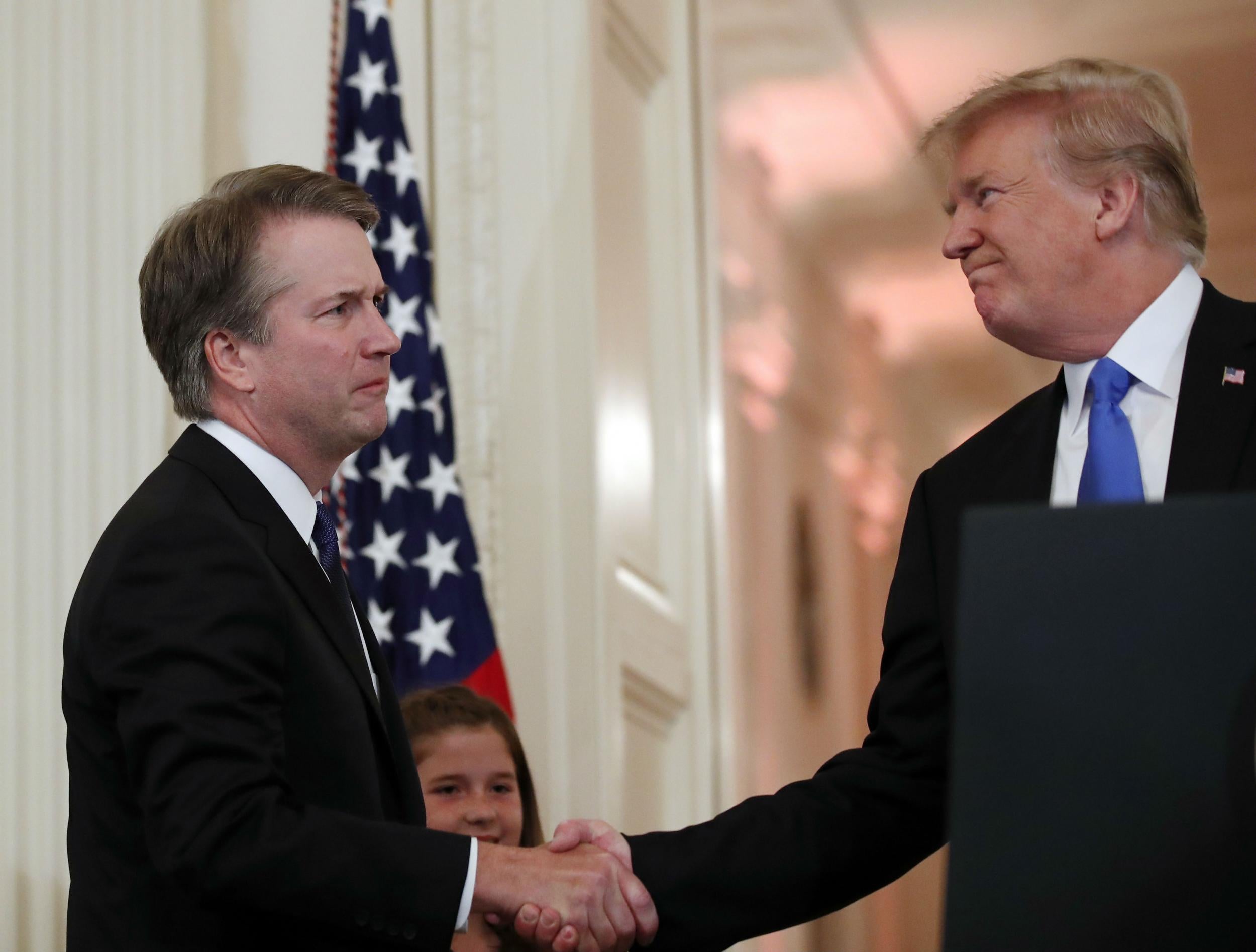 Brett Kavanaugh shakes hands with Donald Trump