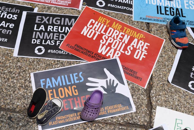 View of signs during a protest against US immigration policies outside the US embassy in Mexico City