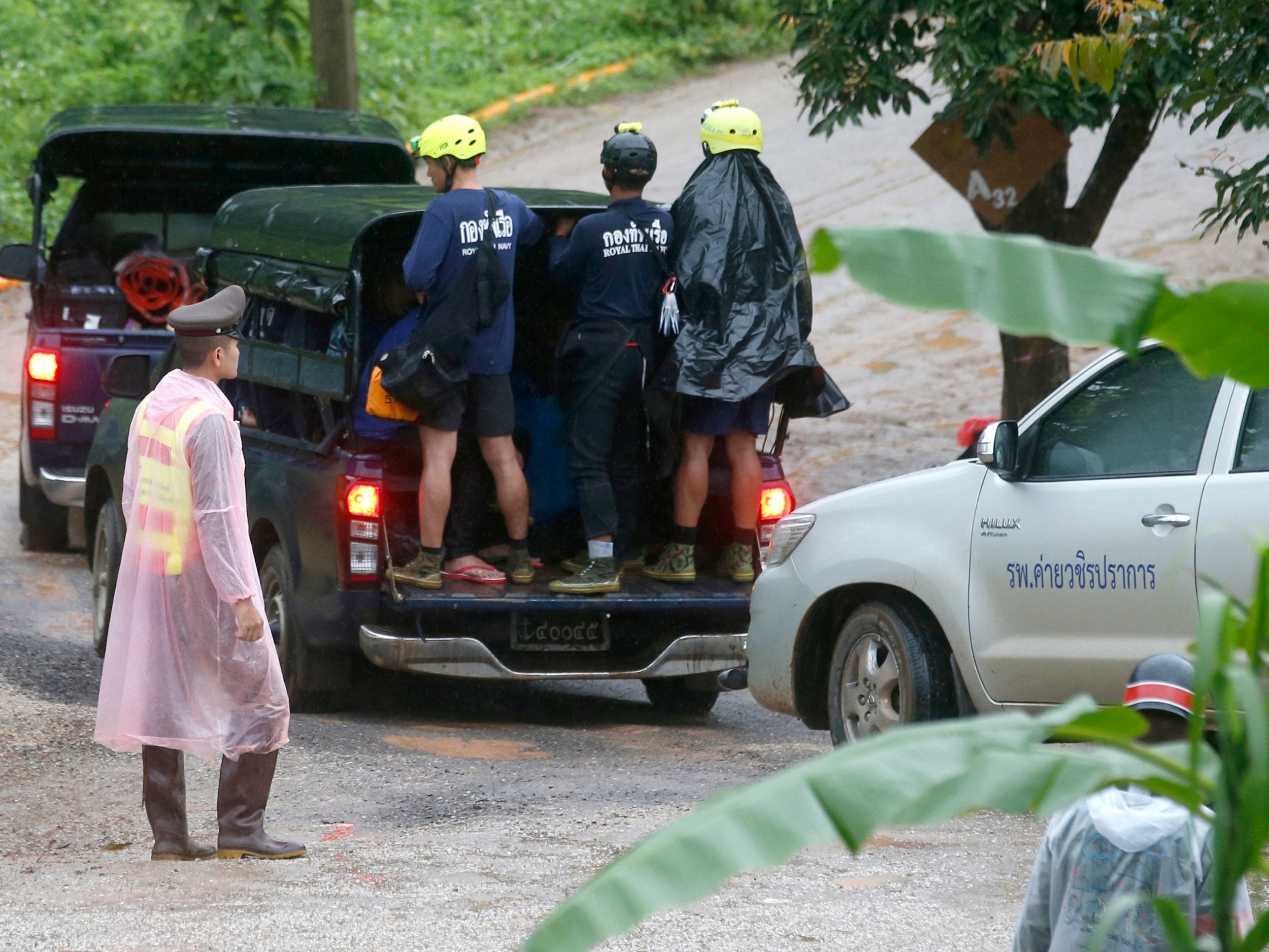 Rescuers move to the entrance to the cave complex on Tuesday, 10 July
