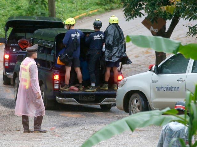 Rescuers move to the entrance to the cave complex on Tuesday, 10 July