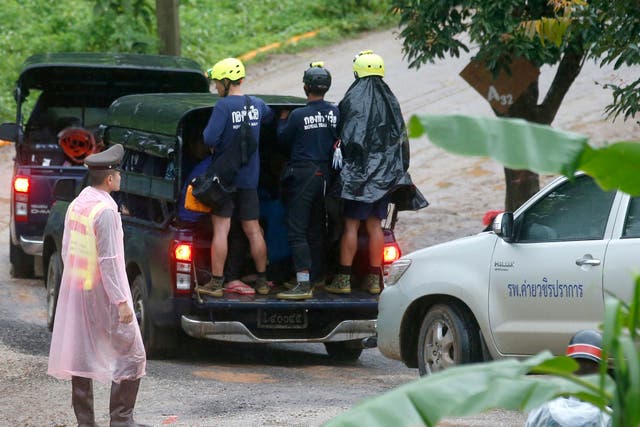 Rescuers move to the entrance to the cave complex on Tuesday, 10 July