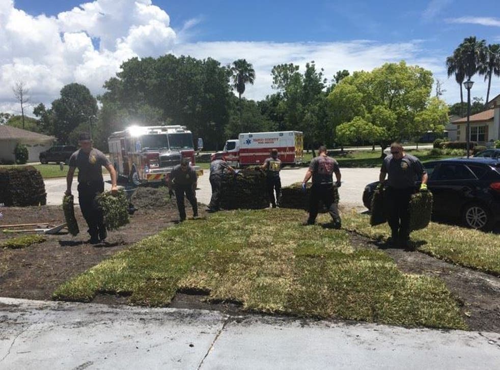 Firefighters in Florida finished off laying the grass for a man who suffered a heart attack