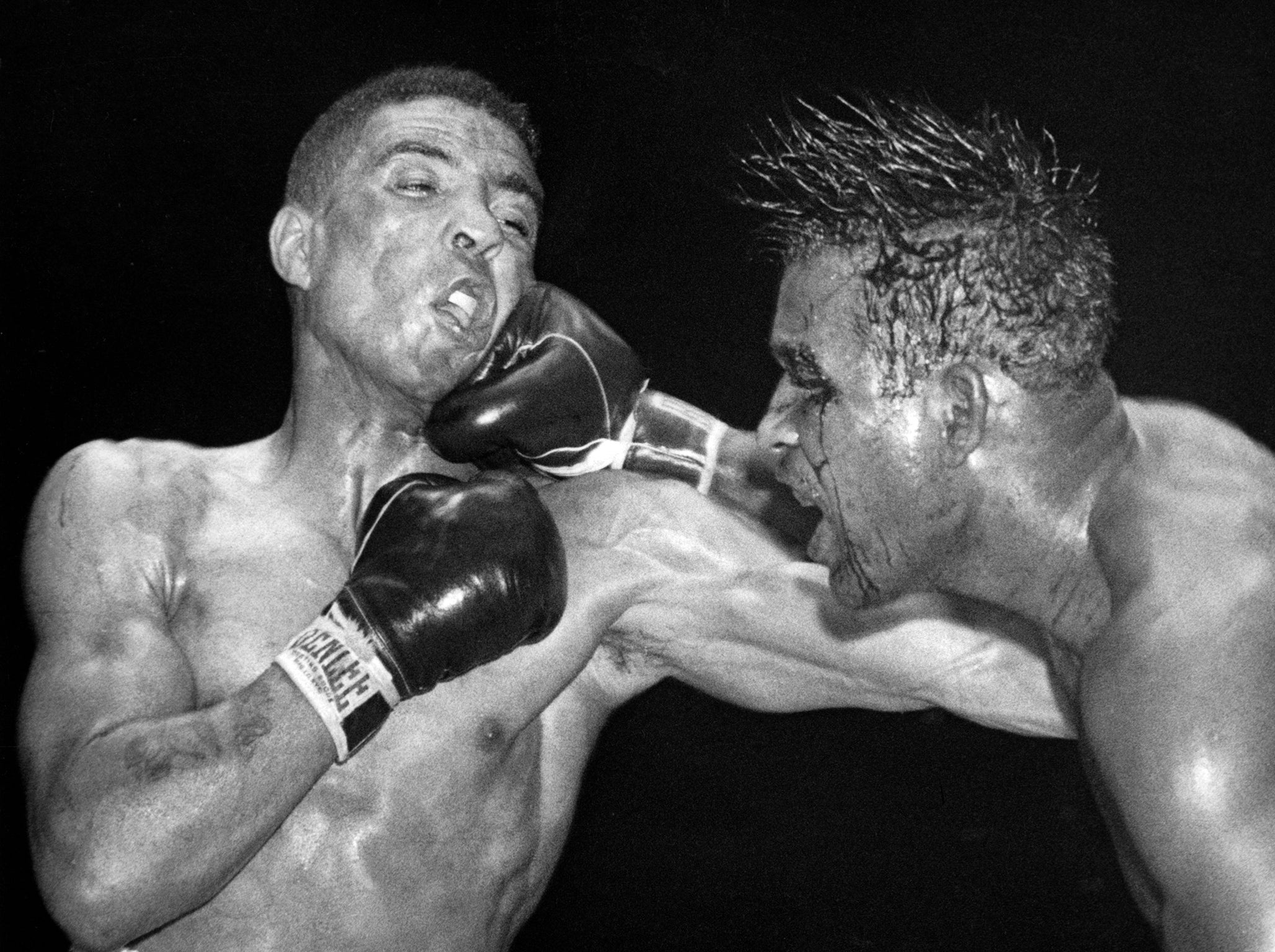 Sugar Ray Robinson throws a hard right to the jaw of Randolph Turpin