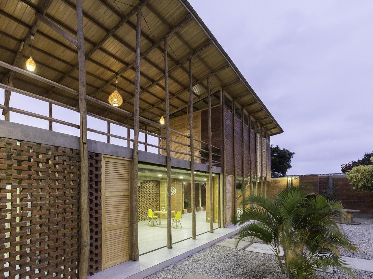 The architects chose not to use any glass in the home, instead incorporating traditional elements such as wooden slat walls that allow ventilation