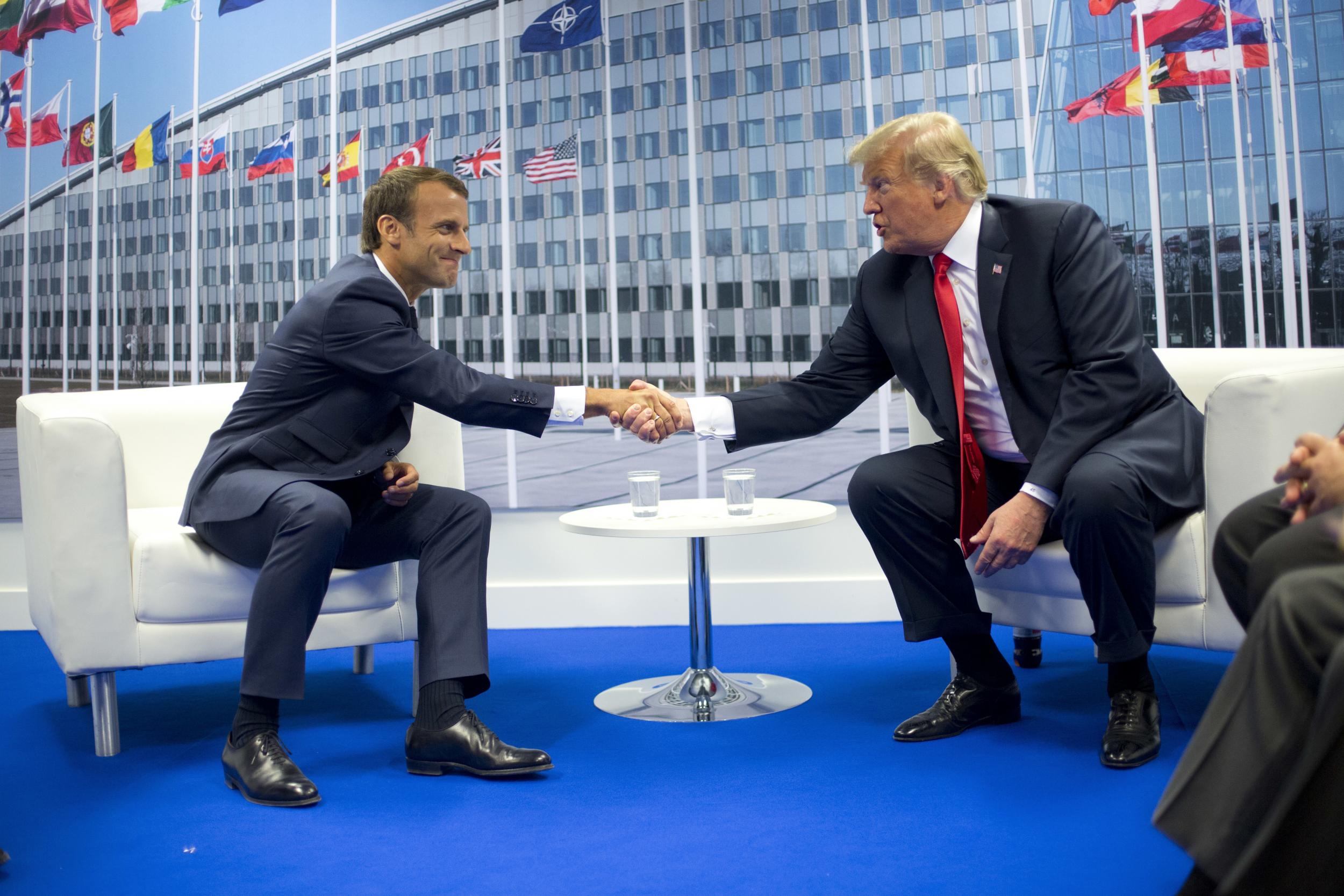 President Donald Trump and French President Emmanuel Macron shake hands during their bilateral meeting