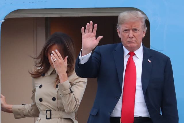US President Donald Trump and US First Lady Melania Trump disembark from Air Force One