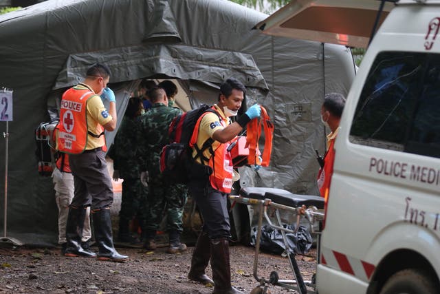 Rescuers work near the cave where 12 young football team members and their coach were trapped in Chiang Rai, Thailand