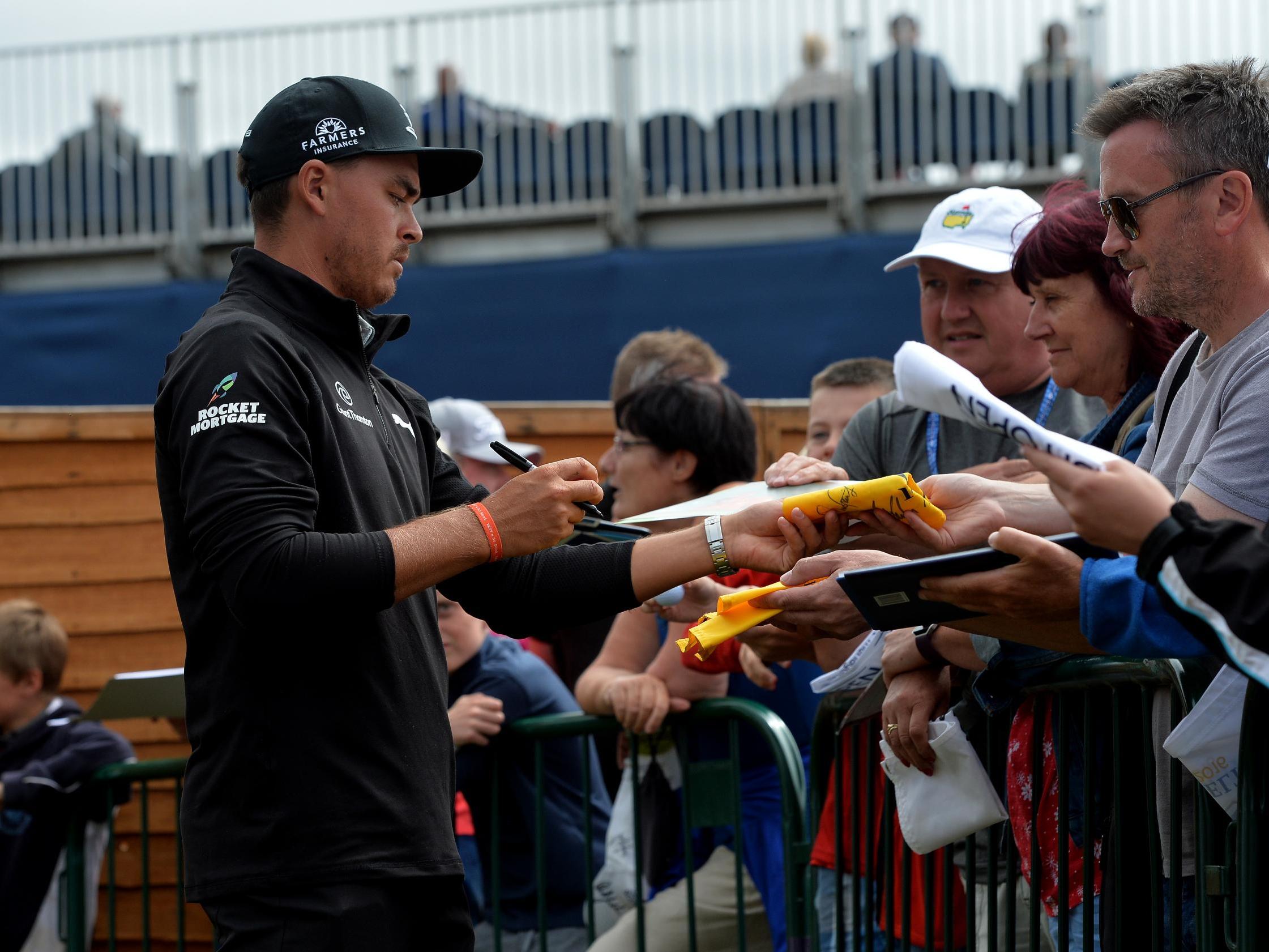 Fowler signs autographs after the opening round